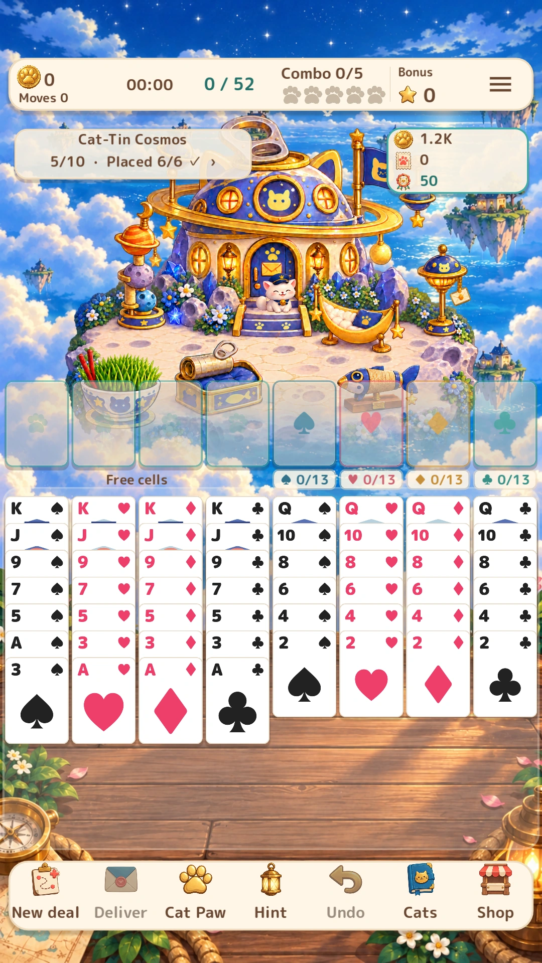 An actual game screen showing a furnished Cat-Tin Cosmos island, a resident cat, eight FreeCell columns, four free cells and game controls.